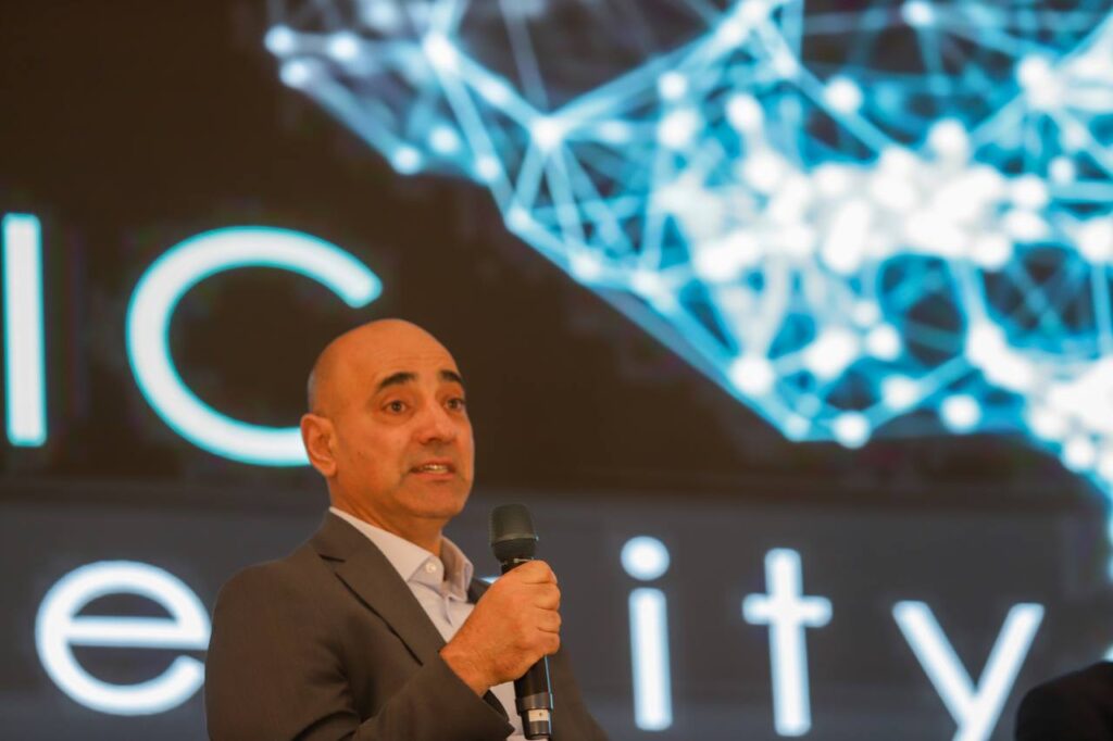 Dr. Freddie Seba delivering an AI governance keynote to a conference audience